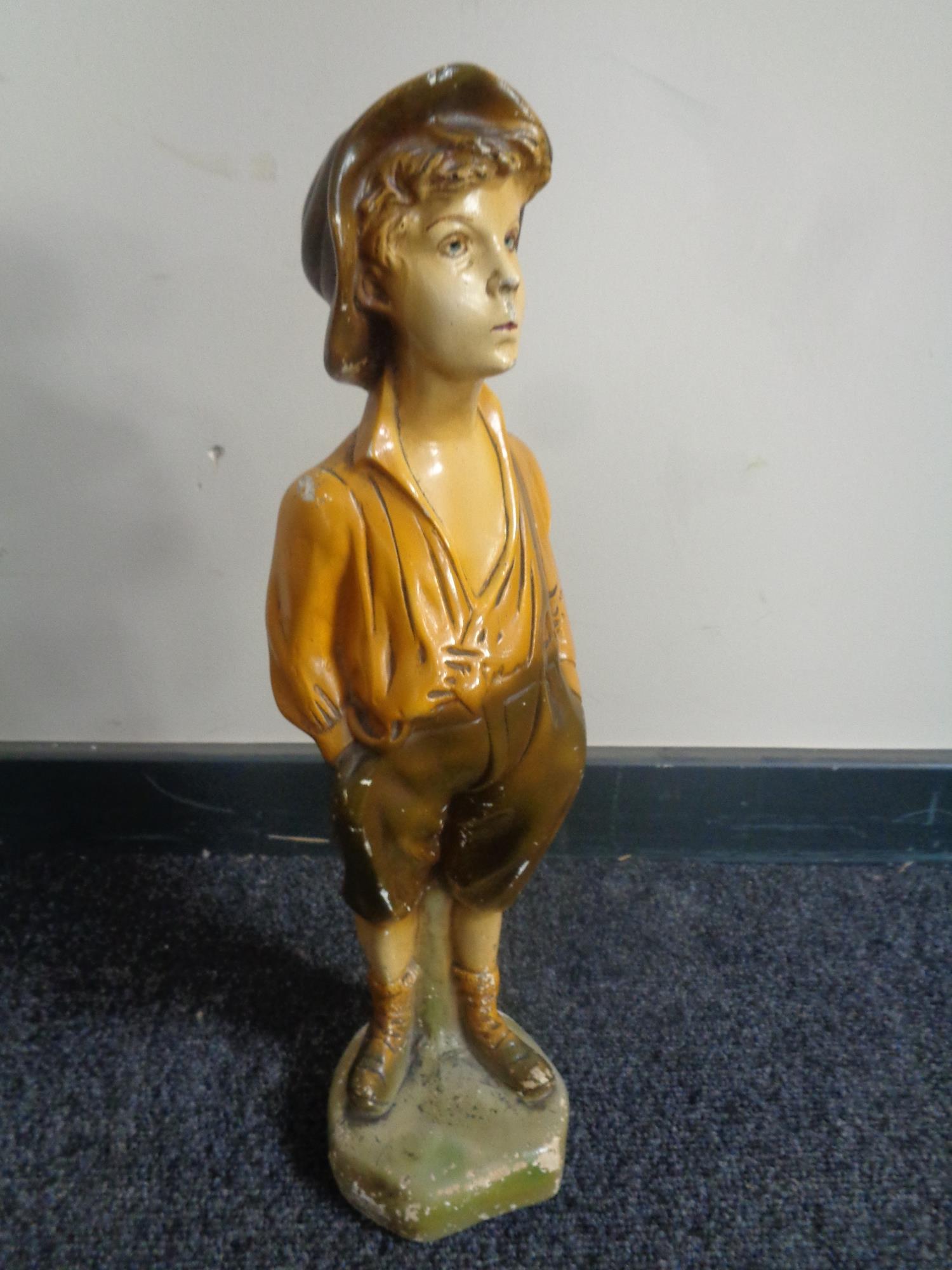 An early 20th century chalk figure of a boy with hands in pocket