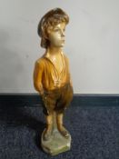 An early 20th century chalk figure of a boy with hands in pocket