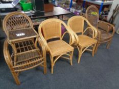 A pair of cane and wicker high backed conservatory chairs together with similar glass topped coffee
