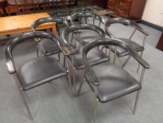 A set of six mid 20th century Danish elbow chairs with black vinyl upholstered seats on tubular