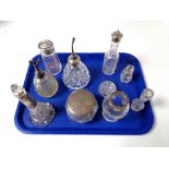 A tray containing a quantity of silver lidded and rimmed dressing table bottles,