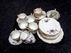 A tray containing a thirty-eight piece antique floral patterned bone china tea service