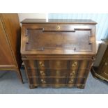 A 20th century continental writing bureau fitted three drawers with brass handles and mounts