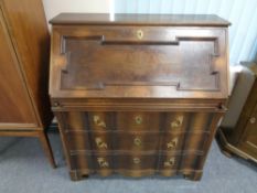 A 20th century continental writing bureau fitted three drawers with brass handles and mounts