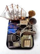 A tray containing vintage telephone, wooden model of a ship, plated photo frames,