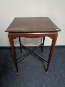 A square Edwardian occasional table on club feet