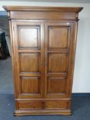 A good quality Barker & Stonehouse Zocalo double door wardrobe fitted two drawers beneath