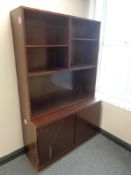 A set of 20th century open bookshelves fitted double door cupboard below in a mahogany finish