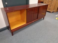 A 20th century triple door low sideboard in a mahogany finish