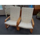 A pair of contemporary beech framed armchairs with cushions