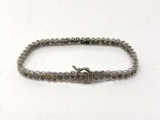 A 10ct white gold diamond set line bracelet, set with 54 diamonds, length 19cm.