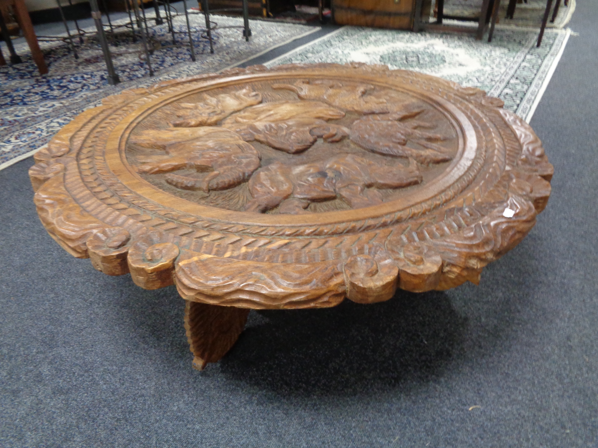 A heavily carved shaped African coffee table depicting animals on elephant supports - Image 2 of 2