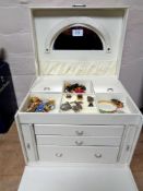 A contemporary leather jewellery chest containing a large quantity of costume brooches, earrings,