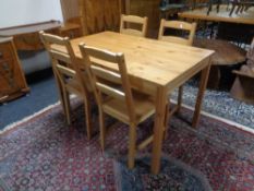 An Ikea pine kitchen table together with four chairs