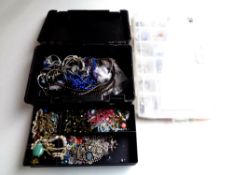 A case containing costume jewellery together with a further case containing jewellery making beads.
