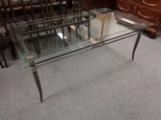 A rectangular glass topped coffee table on metal base (as found)