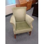 A 20th century green dralon upholstered armchair