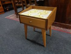 A mid 20th century teak bedside table fitted a drawer on raised legs