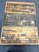 Nine printer's trays containing wooden printing letters