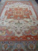 A Serapi Heriz carpet, North-West Iran, with a large central coral medallion on a cream field,