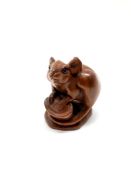 A carved hardwood Chinese netsuke - Rat by a stump