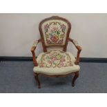 A beech framed salon armchair upholstered in a floral tapestry fabric