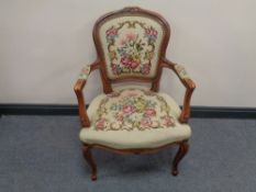 A beech framed salon armchair upholstered in a floral tapestry fabric