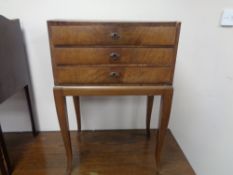 An antique walnut three drawer cutlery chest on raised legs