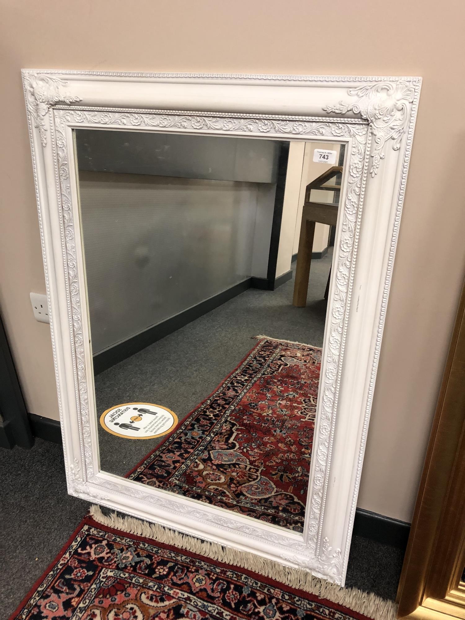 A contemporary white framed mirror 76 x 106 cm