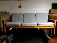 A 20th century pine framed continental three seater settee with grey fabric cushions