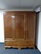 A late Victorian mahogany triple door wardrobe fitted two drawers beneath