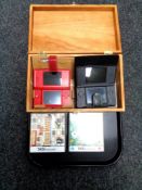 A tray containing two Nintendo DS's with chargers and six assorted games