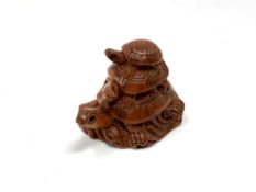 A carved hardwood Chinese netsuke - Three turtles standing on rocks