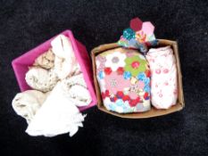 Two boxes containing lace linens and a patchwork quilt