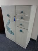 A 20th century painted gentleman's wardrobe fitted cupboard and three drawers
