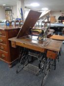 A mid 20th century Singer treadle sewing machine in oak table