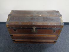 An early 20th century wooden bound dome topped shipping trunk