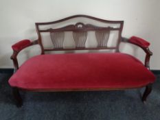 A 19th century mahogany framed salon settee upholstered in a maroon dralon