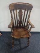 An antique beech kitchen armchair