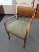 A 20th century oak scroll arm armchair upholstered in a green brocade fabric