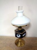 A Duplex brass oil lamp with ceramic reservoir,