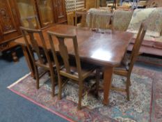 A late 19th century mahogany wind out dining table together with a set of six mahogany chairs