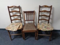 A pair of Edwardian ladder back rush seated bedroom chairs together with a further mahogany bedroom