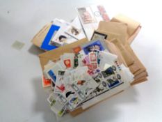 A box containing assorted stamps and first day covers
