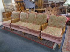 A three piece wood and bergere framed lounge suite upholstered in a pink brocade fabric