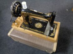 A vintage Singer hand sewing machine in case