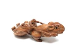 A carved hardwood Chinese netsuke - Rat pulling a turtle