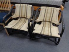 A pair of 20th century bamboo and wicker conservatory armchairs upholstered in a striped fabric