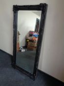 A Victorian style black framed bevelled edge overmantel mirror