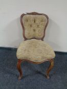 A beech framed French occasional chair upholstered in floral fabric on cabriole legs